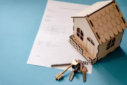 Casa em miniatura, contrato de arrendamento e chaves representando o HAP na Irlanda